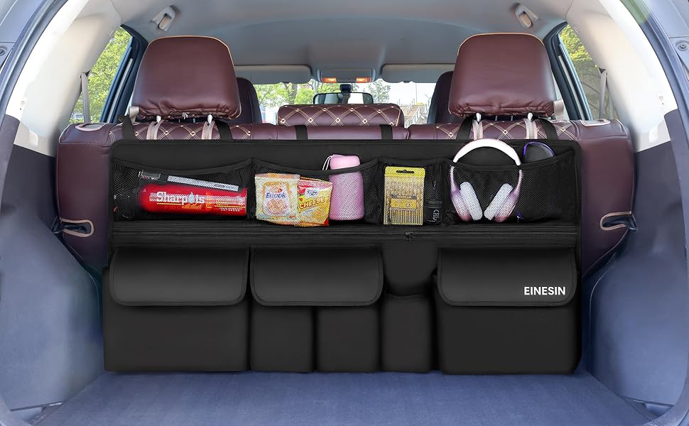 Car trunk organizer with multiple compartments. Black fabric with mesh pockets holding various items. Attaches to rear seats, featuring storage pouches below. Brand name 'ONEGUN' visible.